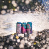 Passionfruit-Gose-Cans-In-Ocean-Surf