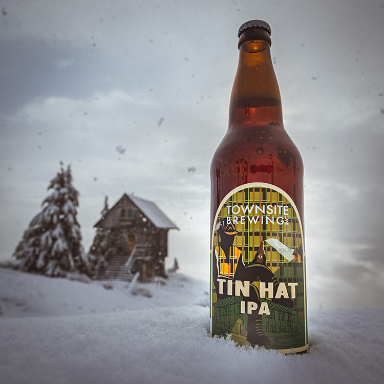 Tin-Hat-IPA-Bottle-In-Snow-Ski-Lodge